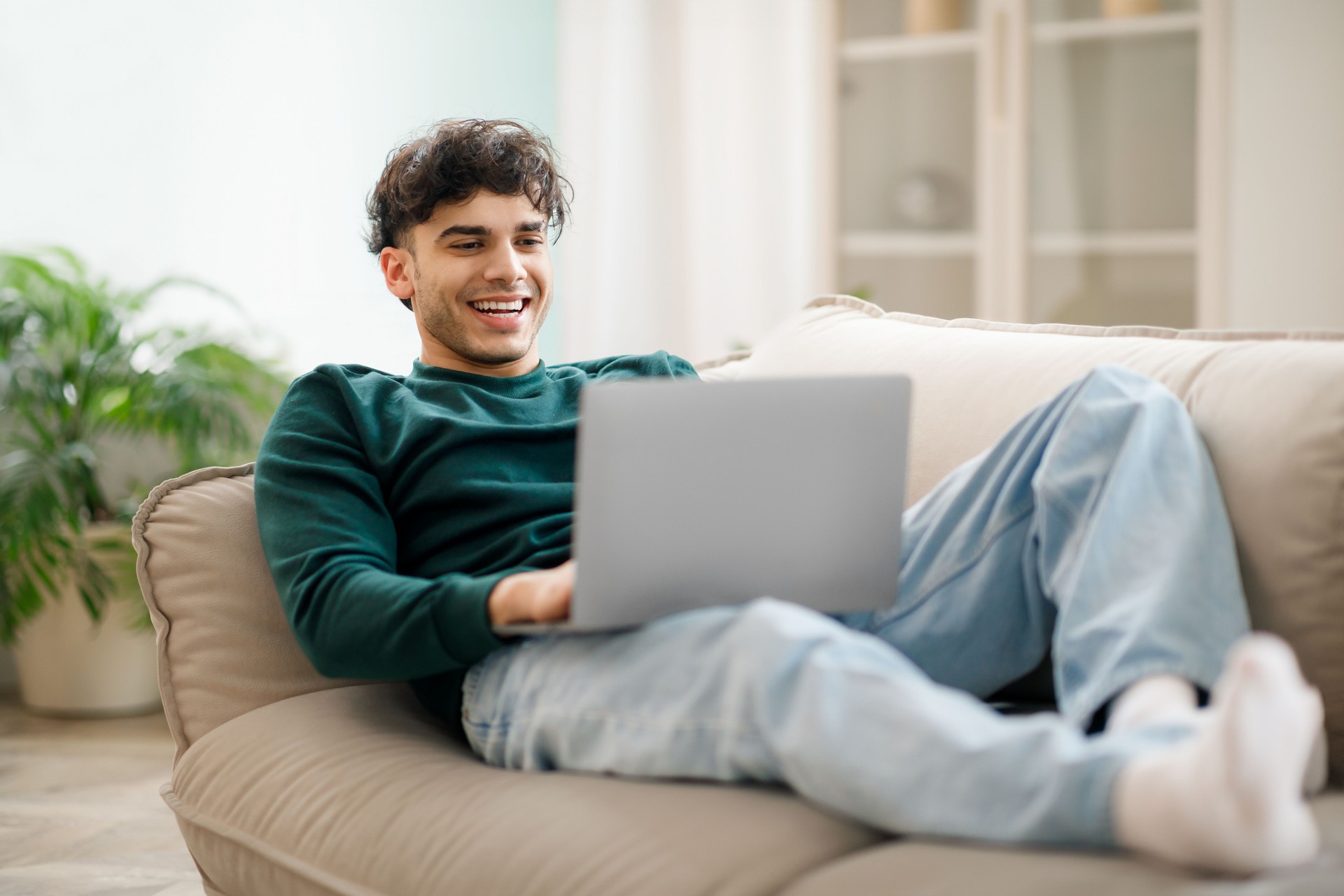 guy works online at laptop resting at home